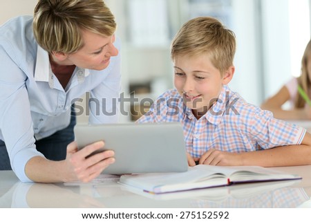 Teacher using digital tablet as educational tool in class
