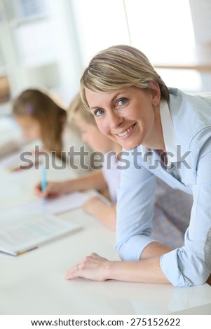 Portrait of smiling teacher in classroom