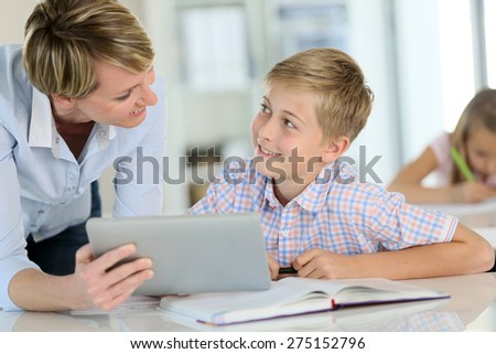 Teacher using digital tablet as educational tool in class
