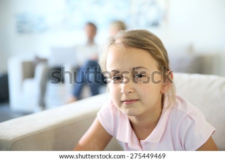 Portrait of 8-year-old girl sitting in sofa