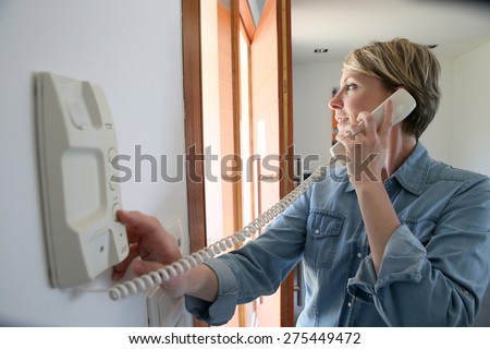 Woman inside home answering intercom