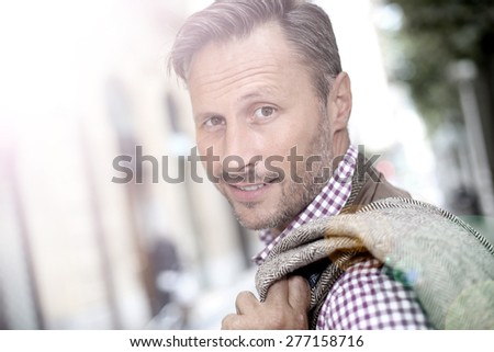 Portrait of elegant smiling man going to work