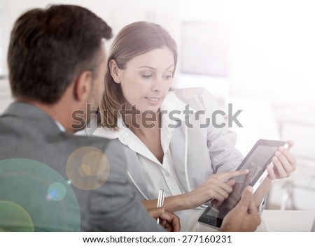 Young woman presenting business plan to financial investor