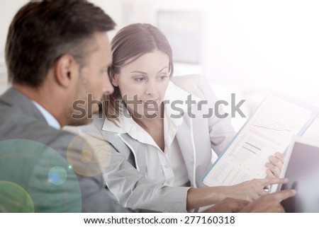 Young woman presenting business plan to financial investor