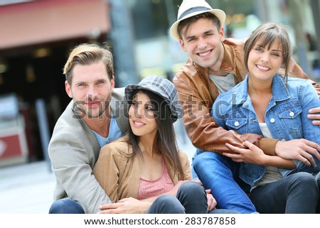 Group of young people hanging out together in town