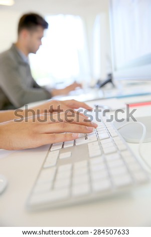 Closeup of hands typing on computer keyboard