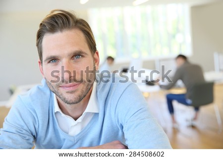 Portrait of middle-aged man with blue shirt in office