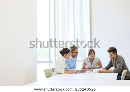 Business people meeting around table in modern space