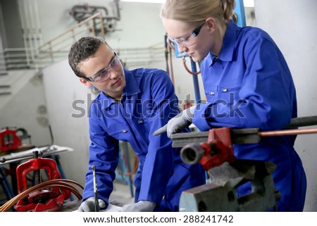 Young people in plumbing professional training