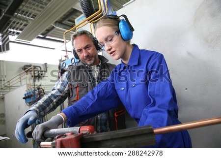 Young woman in professional training to become plumber