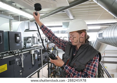 Technician controlling air quality of heating equipment