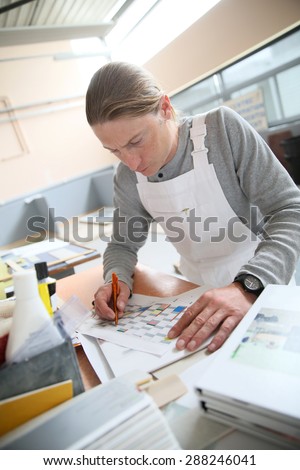 House painter preparing colour sample for house painting
