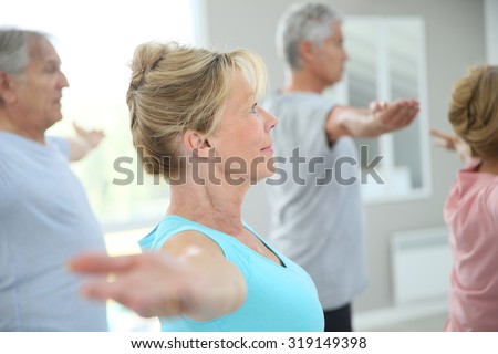 Senior people stretching out in fitness room
