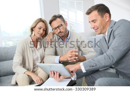 Financial adviser showing terms of contract on tablet