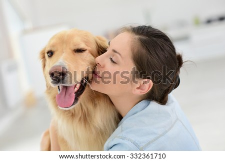 Young woman petting her dog
