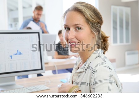 Portrait of student girl working on desktop computer