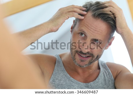 Middle-aged man concerned by hair loss
