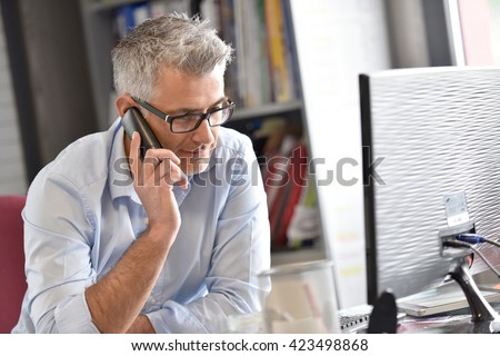 Businessman in office talking on phone