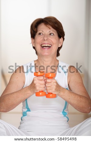 Closeup of senior woman lifting weights