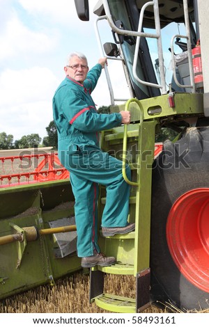 Farmer climbing on harvest machine