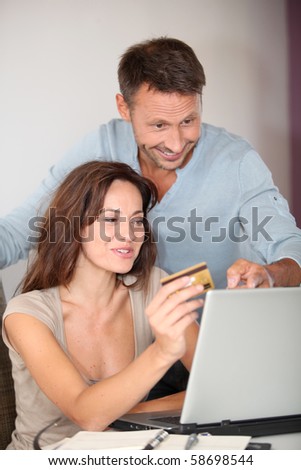 Couple at home shopping on internet