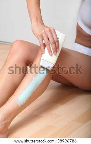 Woman removing hair with wax