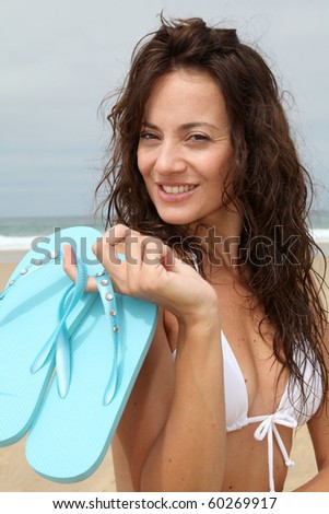 Woman holding flip-flops