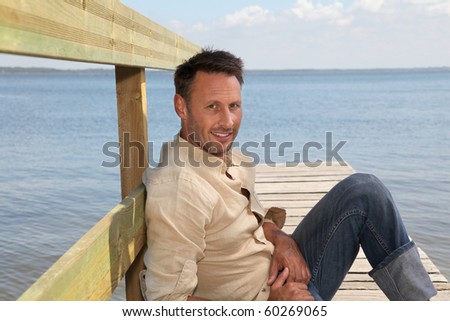 Man on a pontoon by a lake in summer