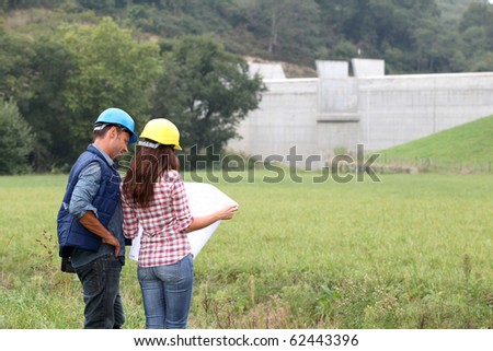 Business people checking plan on construction site