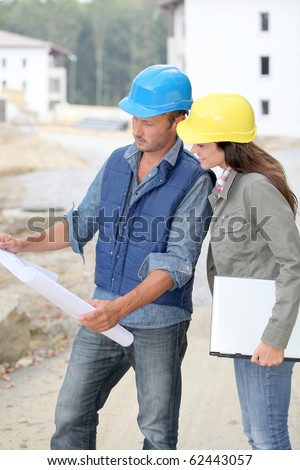 Team of architects checking plans on site
