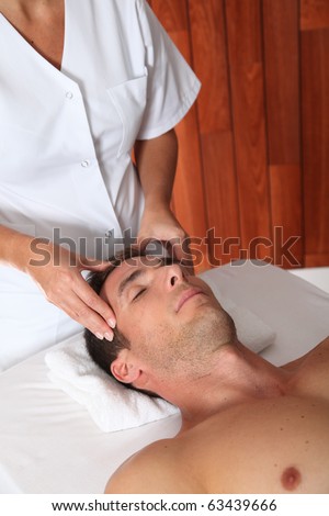 Man having a facial massage in spa center