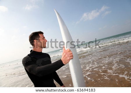 holding surfboard