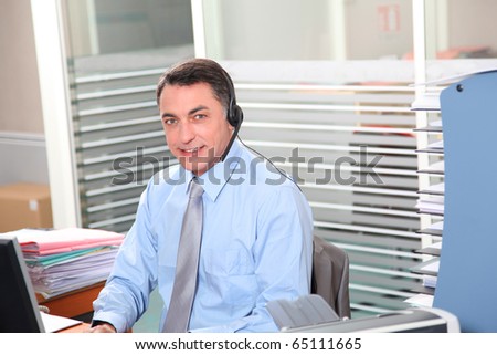 Adult man in the office talking on the phone