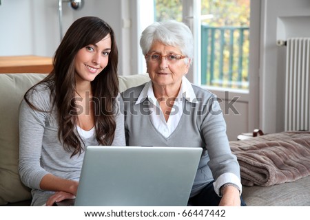 Young woman and elderly woman with laptop computer
