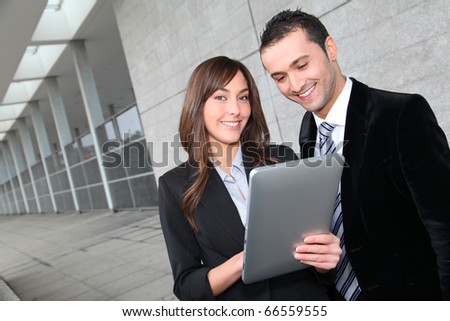 Business people meeting outside with electronic tablet