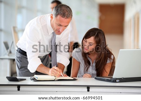 Manager and secretary working in the office