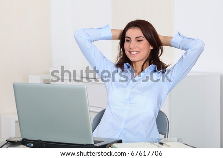 Businesswoman with stretched arms in office