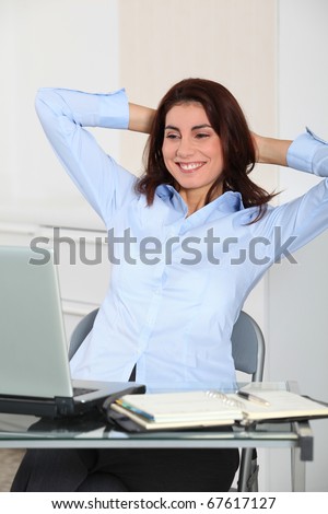 Businesswoman with stretched arms in office