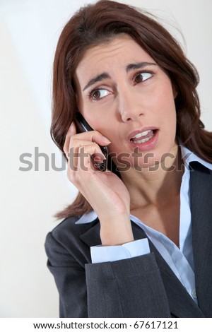 Businesswoman on the phone with preoccupied look