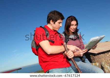 Couple hiking in countryside looking at map