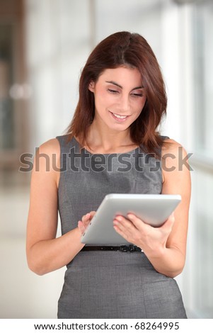 Beautiful businesswoman working on electronic tab