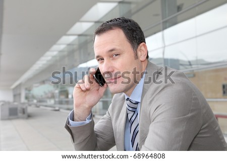 Salesman talking on the phone outside congress center