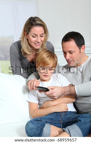 Family playing video game on smart-phone