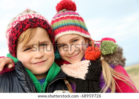 Brother and sister portrait in winter time