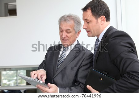 Sales people working on electronic tablet