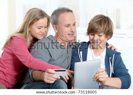 Father and children doing on-line shopping at home