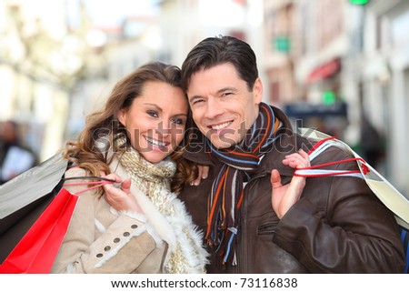 Happy couple doing shopping in town