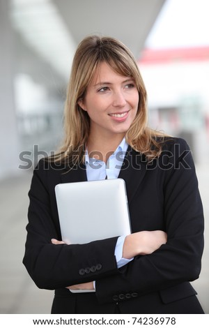 Smiling businesswoman with electronic tablet