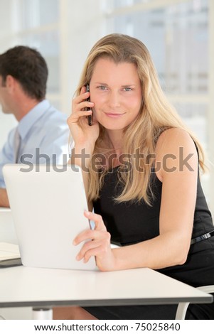 Businesswoman working in office with electronic tablet