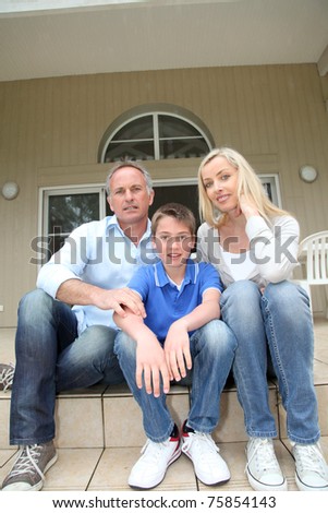 Portrait of family sitting on the front door stairs